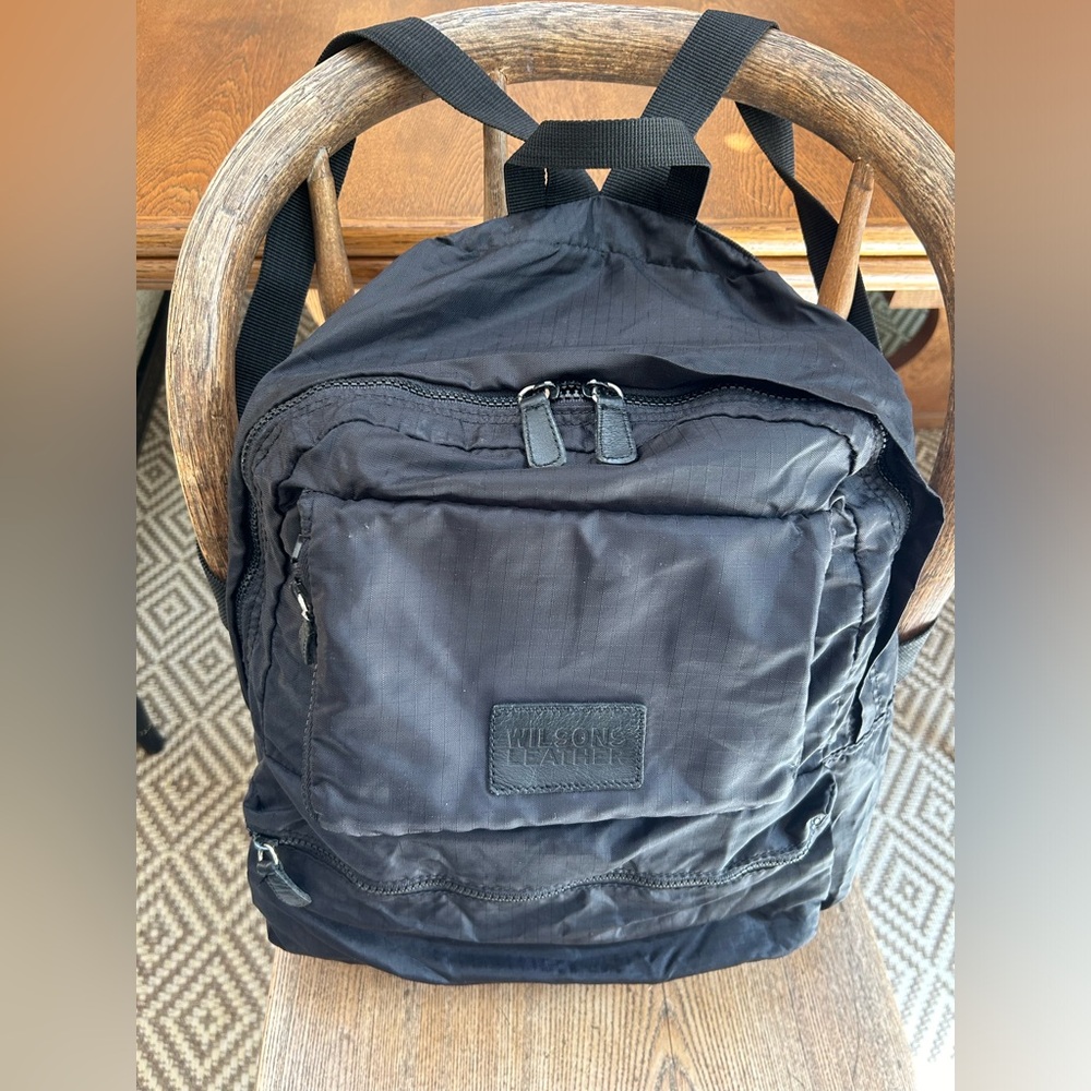 Wilson’s Leather Black nylon backpack, folds/compress out of sight. Ex cond.